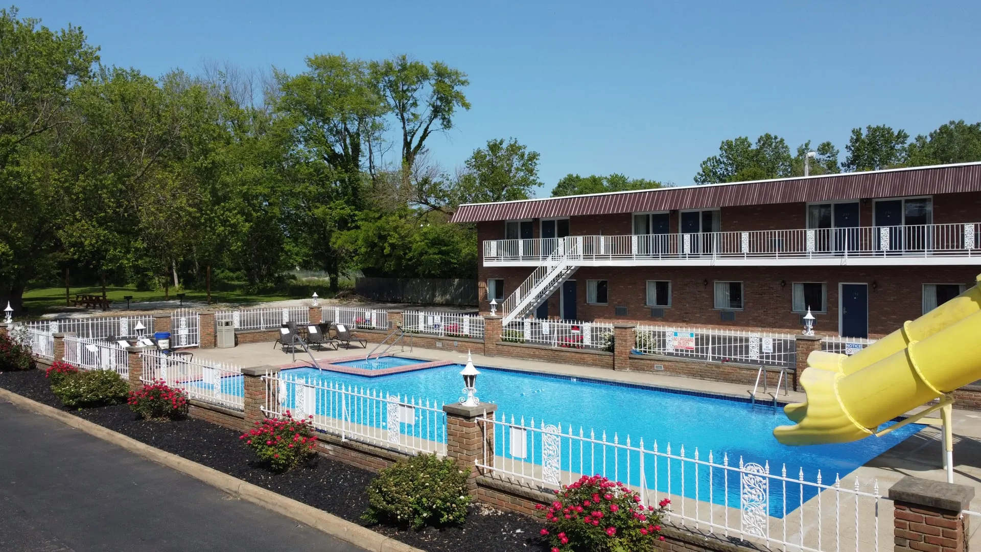 Outdoor pool with water slide and hot tub